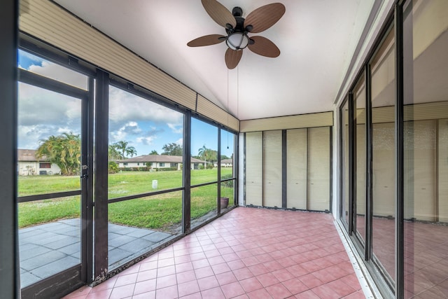 unfurnished sunroom featuring ceiling fan