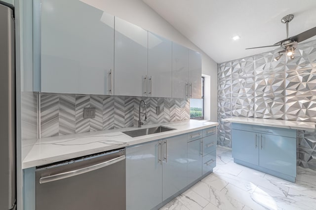 kitchen with sink, vaulted ceiling, ceiling fan, appliances with stainless steel finishes, and light stone counters