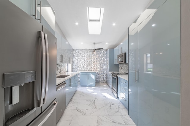 bathroom with a skylight, decorative backsplash, vanity, and an enclosed shower