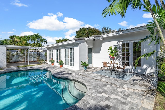 view of pool with a patio area and french doors