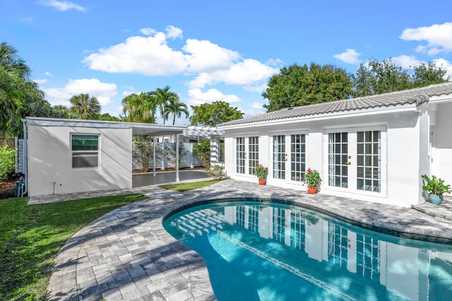 view of swimming pool with a pergola, a patio area, and french doors