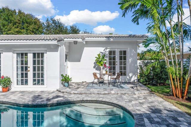 rear view of house featuring a patio area and french doors