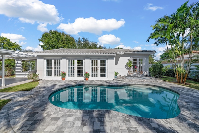 rear view of property with french doors, a pergola, and a patio area