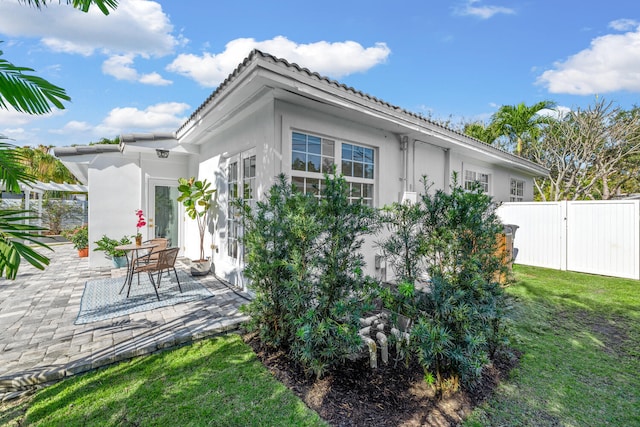 rear view of house with a patio and a yard