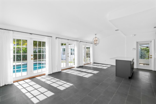 kitchen featuring built in refrigerator, french doors, decorative light fixtures, and gray cabinets