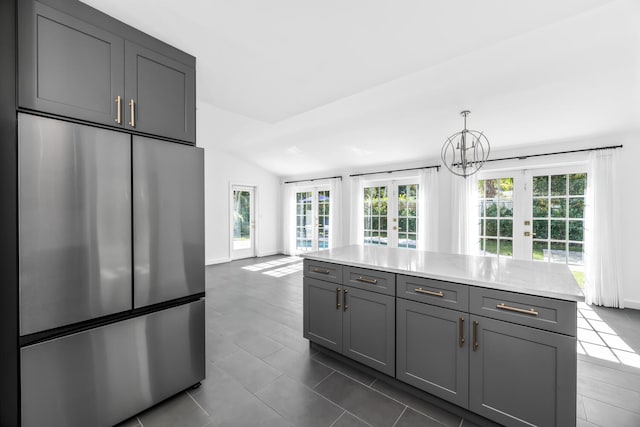 kitchen featuring french doors, decorative light fixtures, gray cabinets, and built in fridge