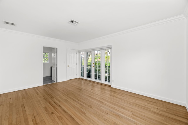 unfurnished room with light wood-type flooring and crown molding