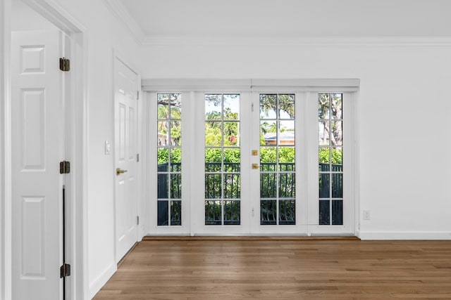 doorway to outside featuring crown molding and hardwood / wood-style flooring