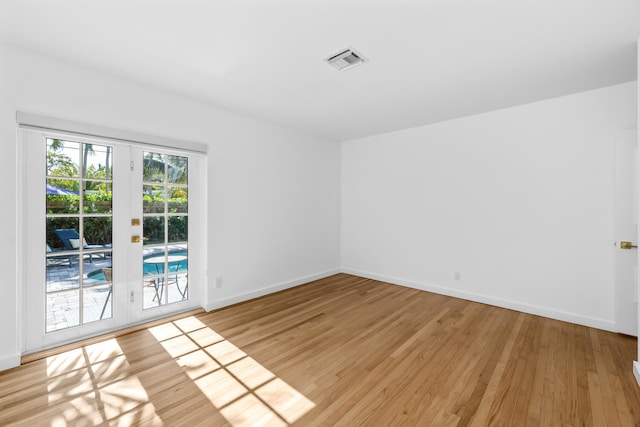 spare room featuring light hardwood / wood-style flooring