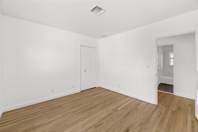 unfurnished room with light wood-type flooring