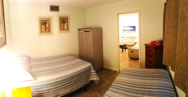 bedroom featuring dark tile patterned floors