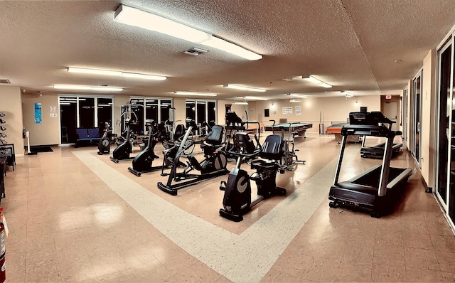 exercise room featuring a textured ceiling and pool table