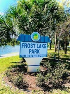 community / neighborhood sign featuring a water view