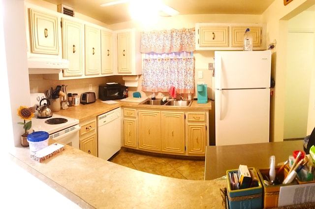 kitchen featuring decorative backsplash, light tile patterned floors, white appliances, and sink