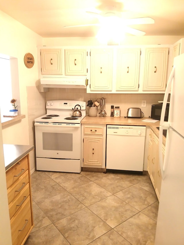 kitchen with backsplash and white appliances