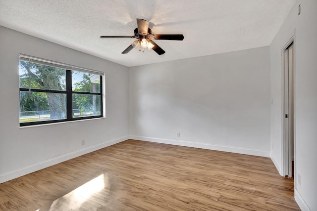 unfurnished room with ceiling fan, light hardwood / wood-style floors, and a textured ceiling