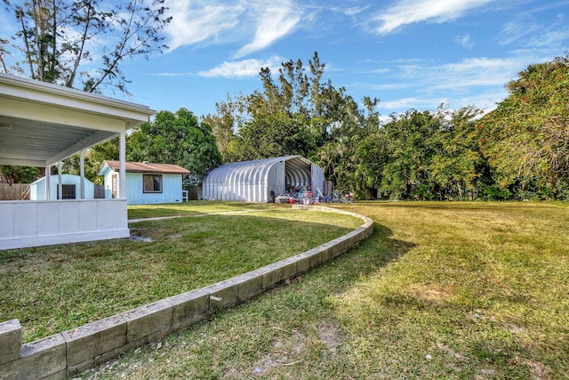 view of yard with a carport and an outdoor structure