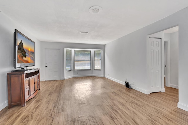 unfurnished living room with light wood-type flooring