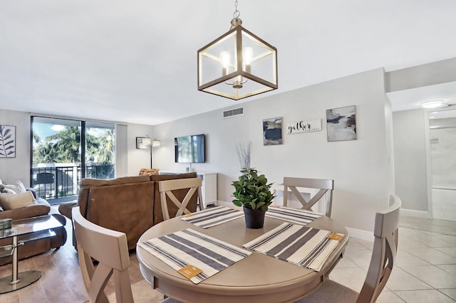 tiled dining area with a chandelier