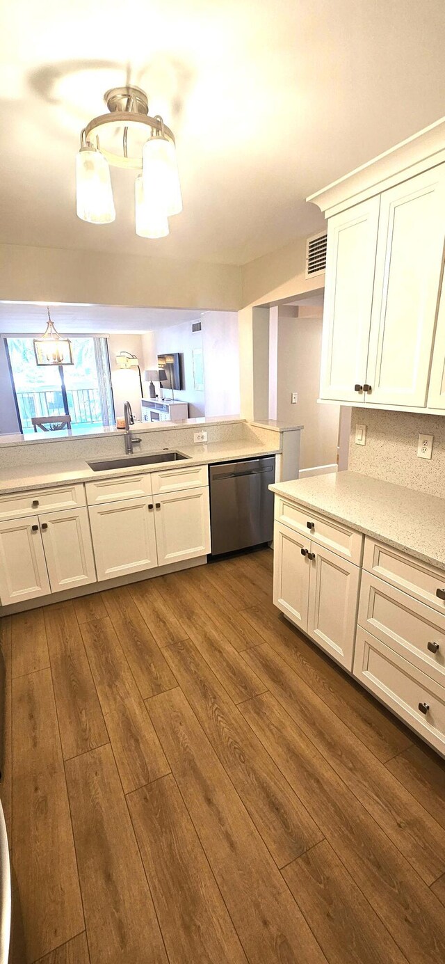 bedroom with connected bathroom and light hardwood / wood-style flooring