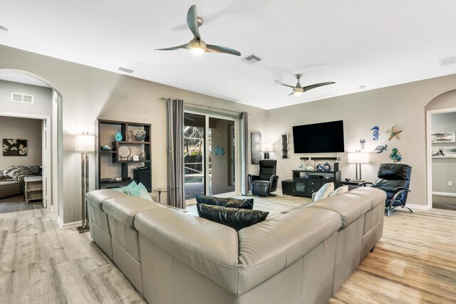 living room with ceiling fan and light hardwood / wood-style floors