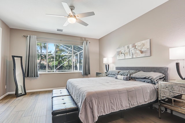 bedroom with access to outside, ceiling fan, and light wood-type flooring