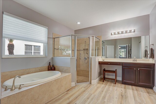 bathroom featuring vanity, wood-type flooring, and a shower with shower door