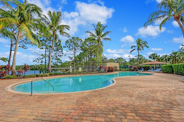 exterior space featuring a water view, a gazebo, and a lawn