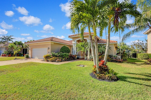 mediterranean / spanish home with a garage and a front yard