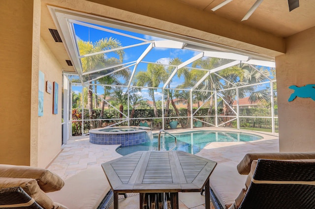 view of pool with an in ground hot tub, a lanai, and a patio