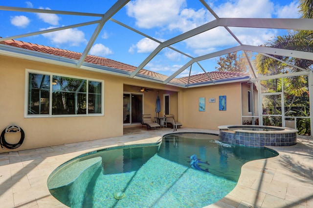 view of swimming pool with a lanai, a patio area, and an in ground hot tub