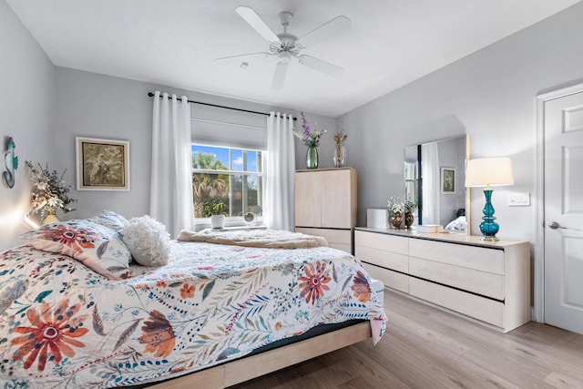 bedroom with light hardwood / wood-style flooring and ceiling fan