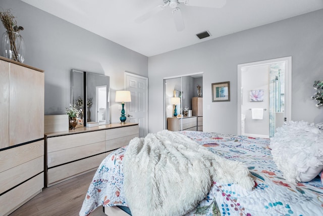 bedroom featuring ensuite bathroom, ceiling fan, and light wood-type flooring