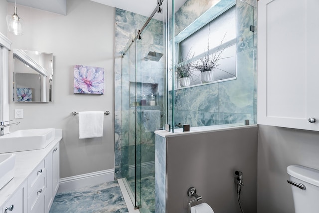 bathroom featuring vanity, toilet, and walk in shower