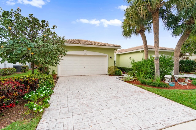 view of front of property with a garage and cooling unit