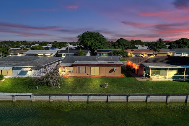 view of back house at dusk