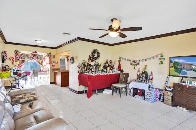 tiled living room with ceiling fan and crown molding