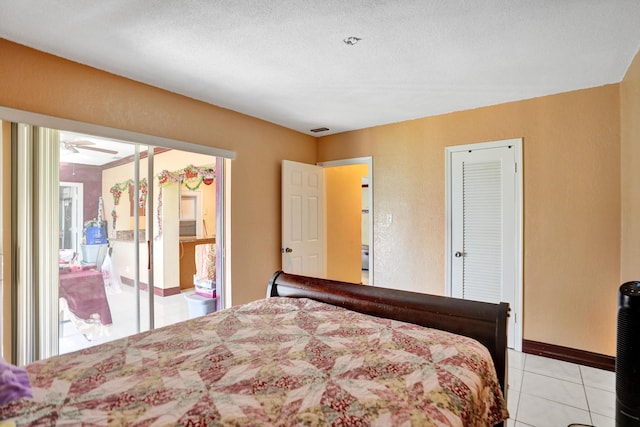 bedroom featuring light tile patterned floors and a textured ceiling