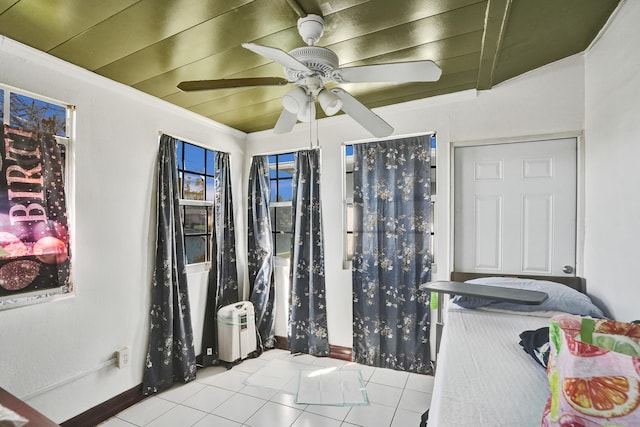 interior space featuring tile patterned floors, ceiling fan, crown molding, and wood ceiling