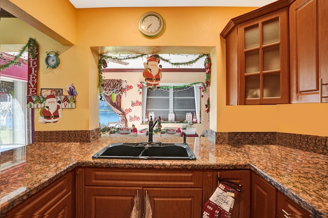 kitchen featuring sink and dark stone counters