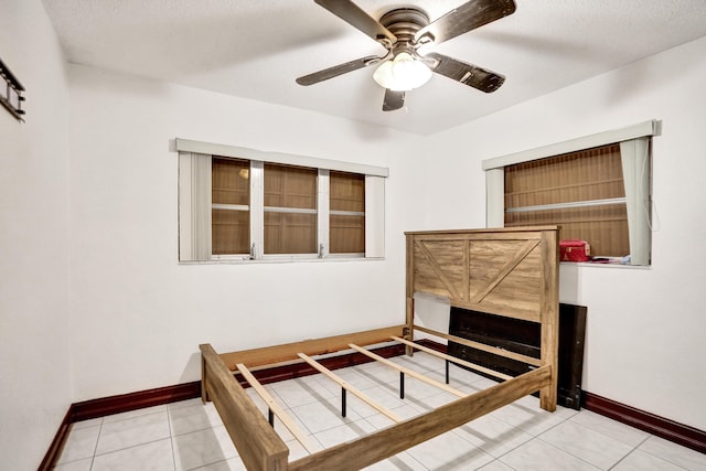 unfurnished bedroom with ceiling fan and light tile patterned flooring