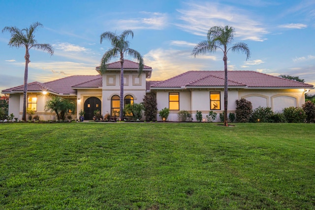 mediterranean / spanish-style home with a yard