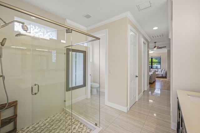 bathroom featuring walk in shower, ornamental molding, vanity, ceiling fan, and toilet