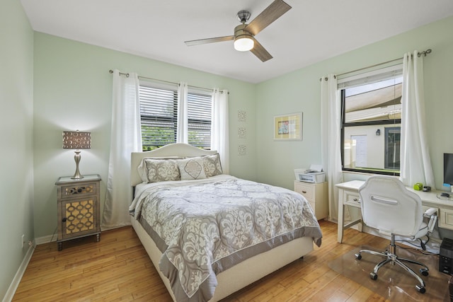 bedroom with light hardwood / wood-style flooring and ceiling fan