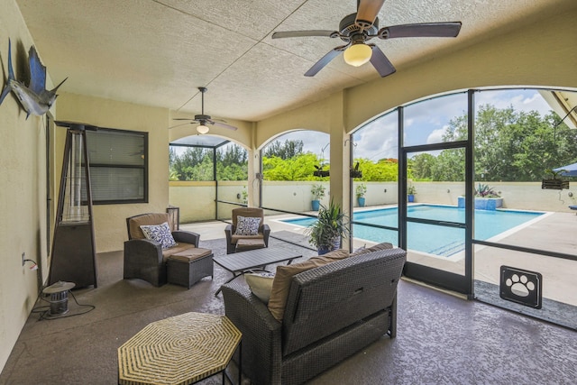 sunroom / solarium featuring a wealth of natural light and ceiling fan