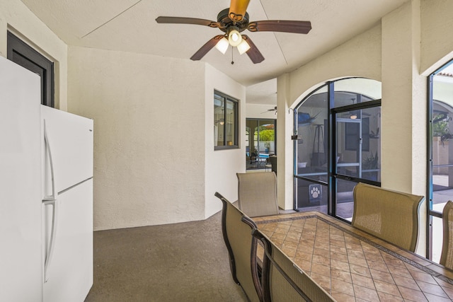 interior space featuring ceiling fan and a balcony