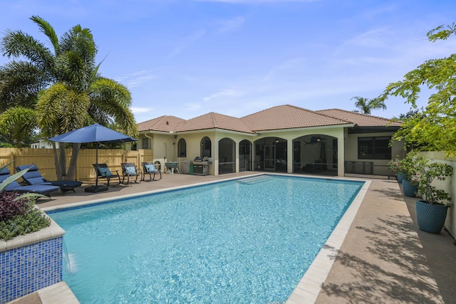 view of swimming pool featuring a patio and grilling area