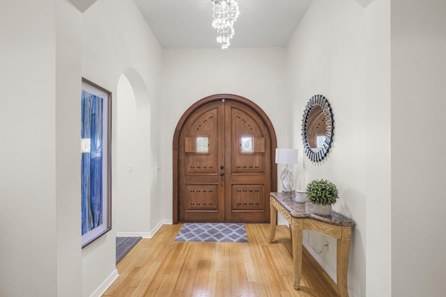 entrance foyer featuring hardwood / wood-style floors and a chandelier