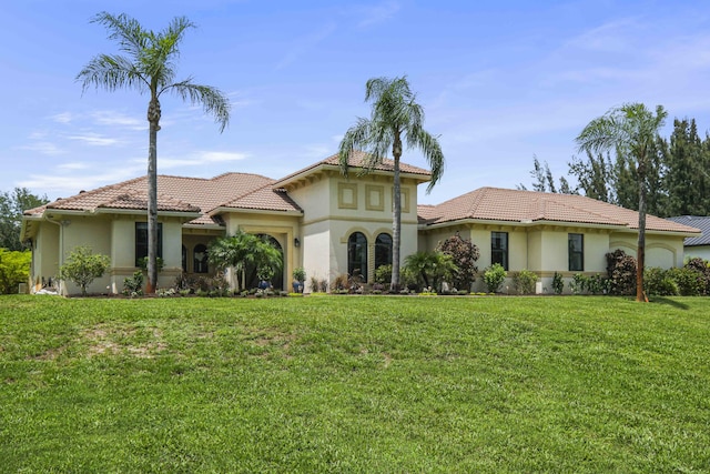 mediterranean / spanish house with a front yard