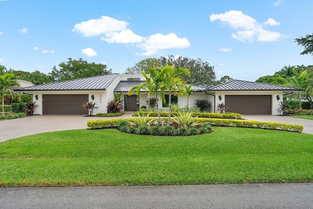 single story home with a garage and a front lawn